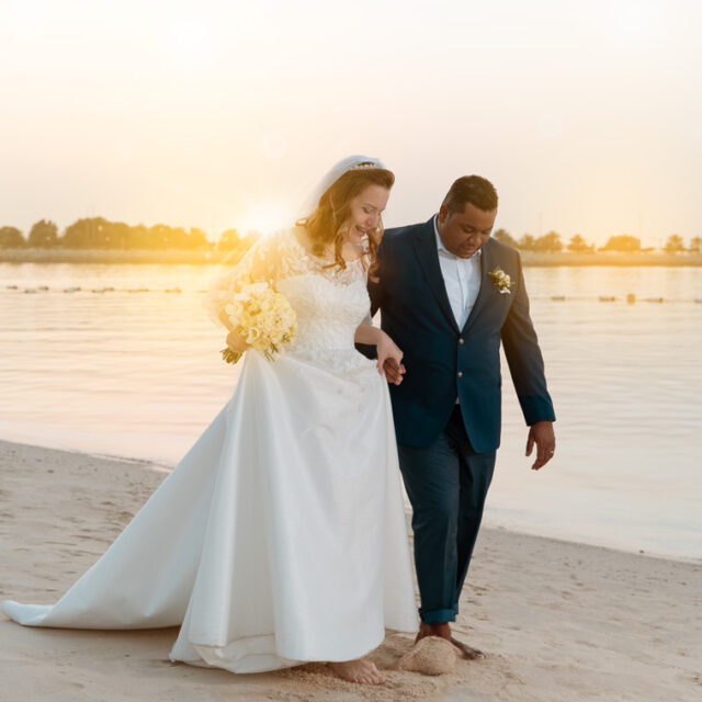 wedding-beach-outdoor-walking-with-holding-hands-sunflare