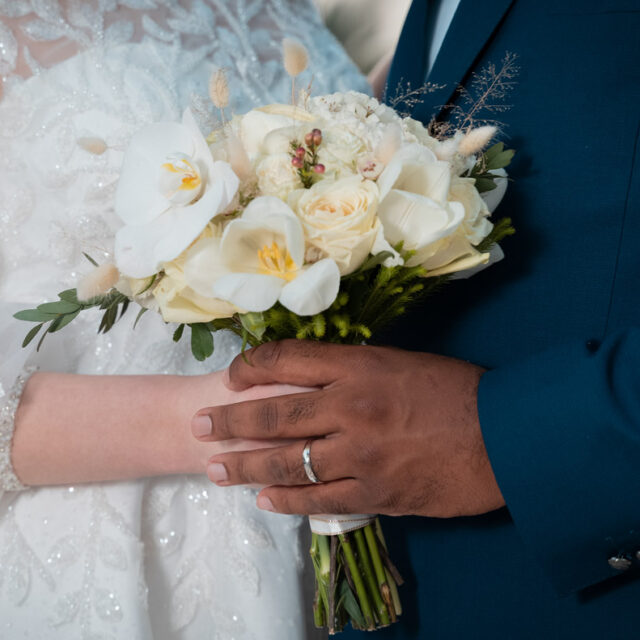 wedding-holding-hands-rings-flowers